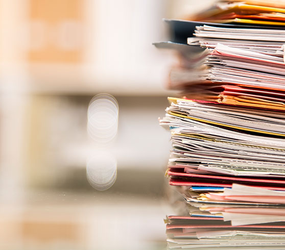 Practice-Areas---Corporate---Government-Investigations---Content---Large-stack-of-files,-documents,-paperwork-on-des